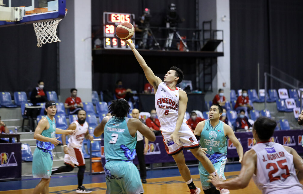 Ginebra’s Scottie Thompson makes his signature finger roll over Jason Perkins of Phoenix. (Photo from PBA)