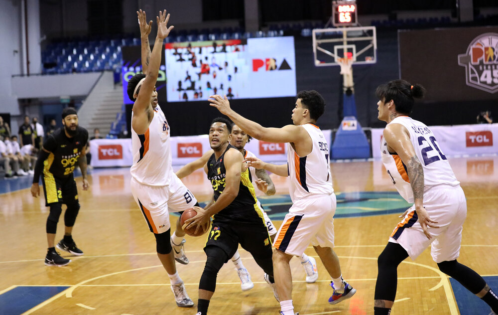 TNT’s Jayson Castro rolls to the rim against three Meralco defenders. (Photo from PBA)