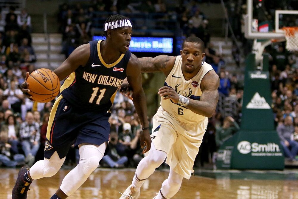 Jrue Holiday drives past Eric Bledsoe during a Pelicans-Bucks game. (Photo by Dylan Buell/Getty Images)