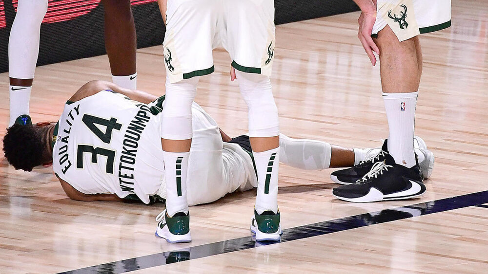 Milwaukee’s Giannis Antetokounmpo exited Game 4 early after re-aggravating an ankle injury. (Photo by Douglas P. DeFelice/Getty Images)