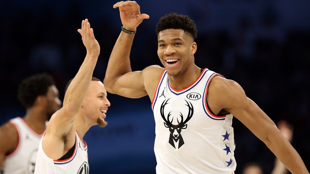 Giannis Antetokounmpo celebrating with Steph Curry during the 2019 All-Star Game. (Photo via justallstar.com )