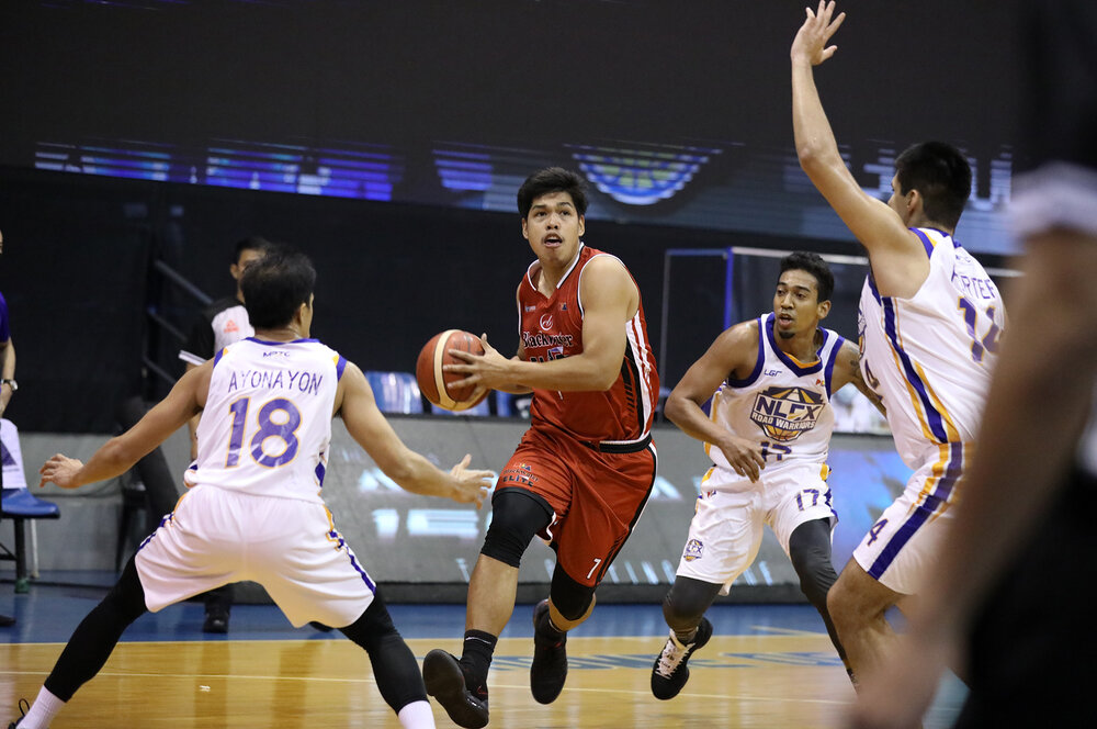 Don Trollano steps past Mike Ayonayon and Kenneth Ighalo of NLEX. (Photo from PBA)