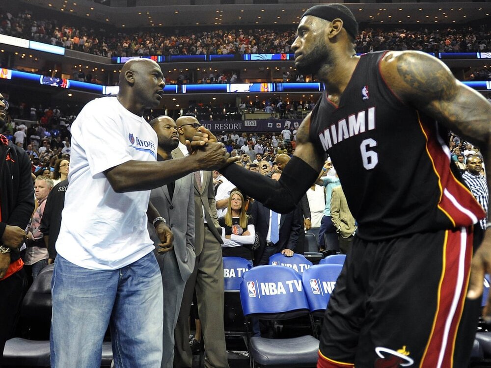 LeBron James and Michael Jordan during a playoff game between the Miami Heat and the Charlotte Hornets. (Photo via Charlotte Observer/Getty Images)