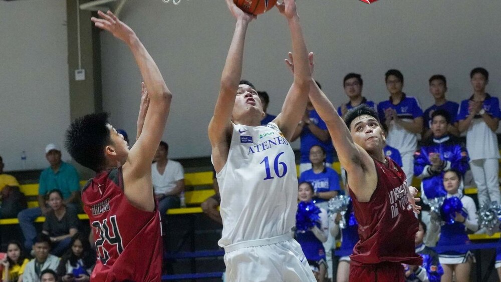 Lazaro going up for a shot inside the paint against two UP defenders. (Photo via ESPN)