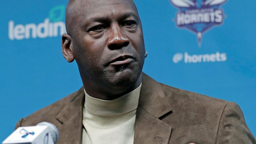 Hornets owner Michael Jordan now acts as bridge in talks between players and owners. (Photo by Chuck Burton/AP)